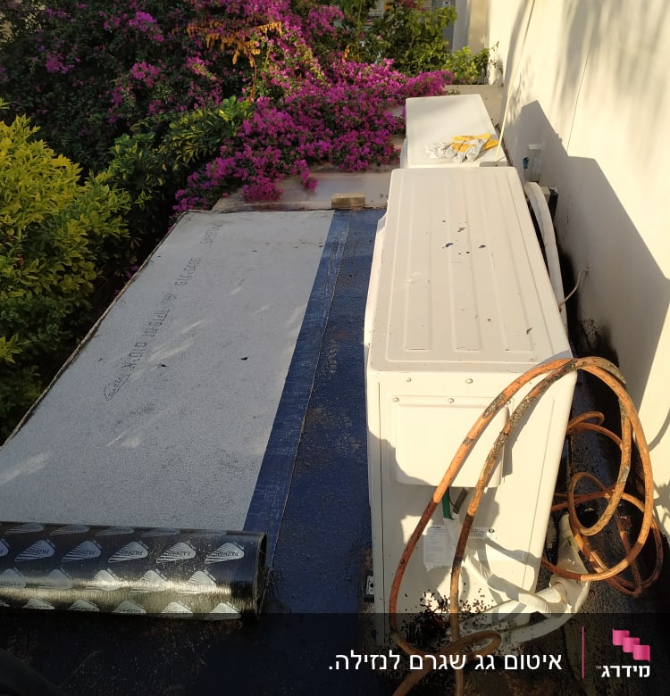 יריעה לאיטום גג ליד מזגן וחוטים